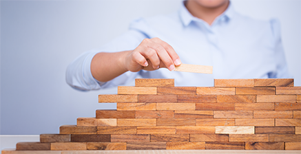 Man stacking wooden blocks