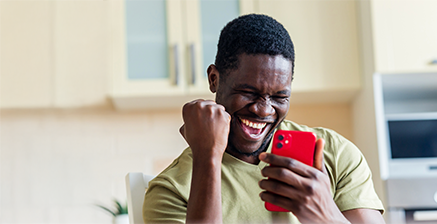 Excited man holding his phone