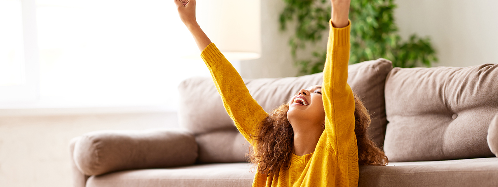 woman with her arms raised in excitement