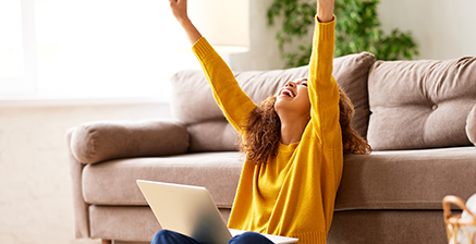 Excited woman with laptop