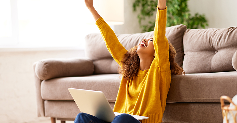 woman with her arms raised in excitement