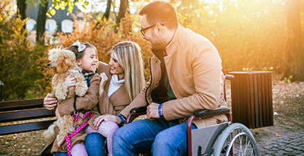 Man in wheel chair with his family