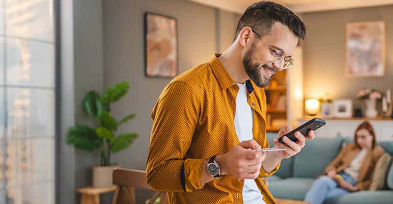 Man making payments on his phone