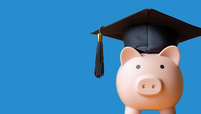 A piggy bank wearing a graduation cap