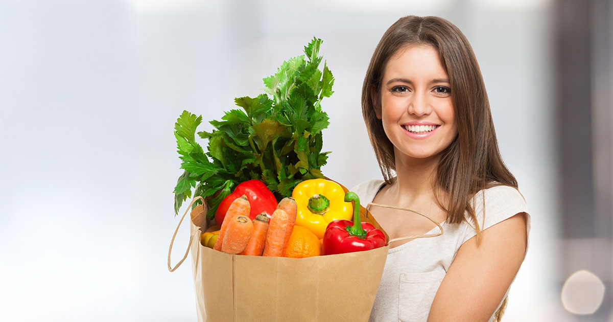 girl holding a bag of groceries