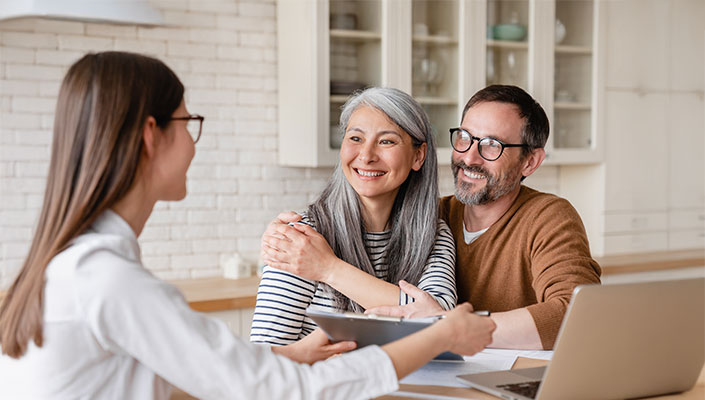 Happy couple reviewing their loan options